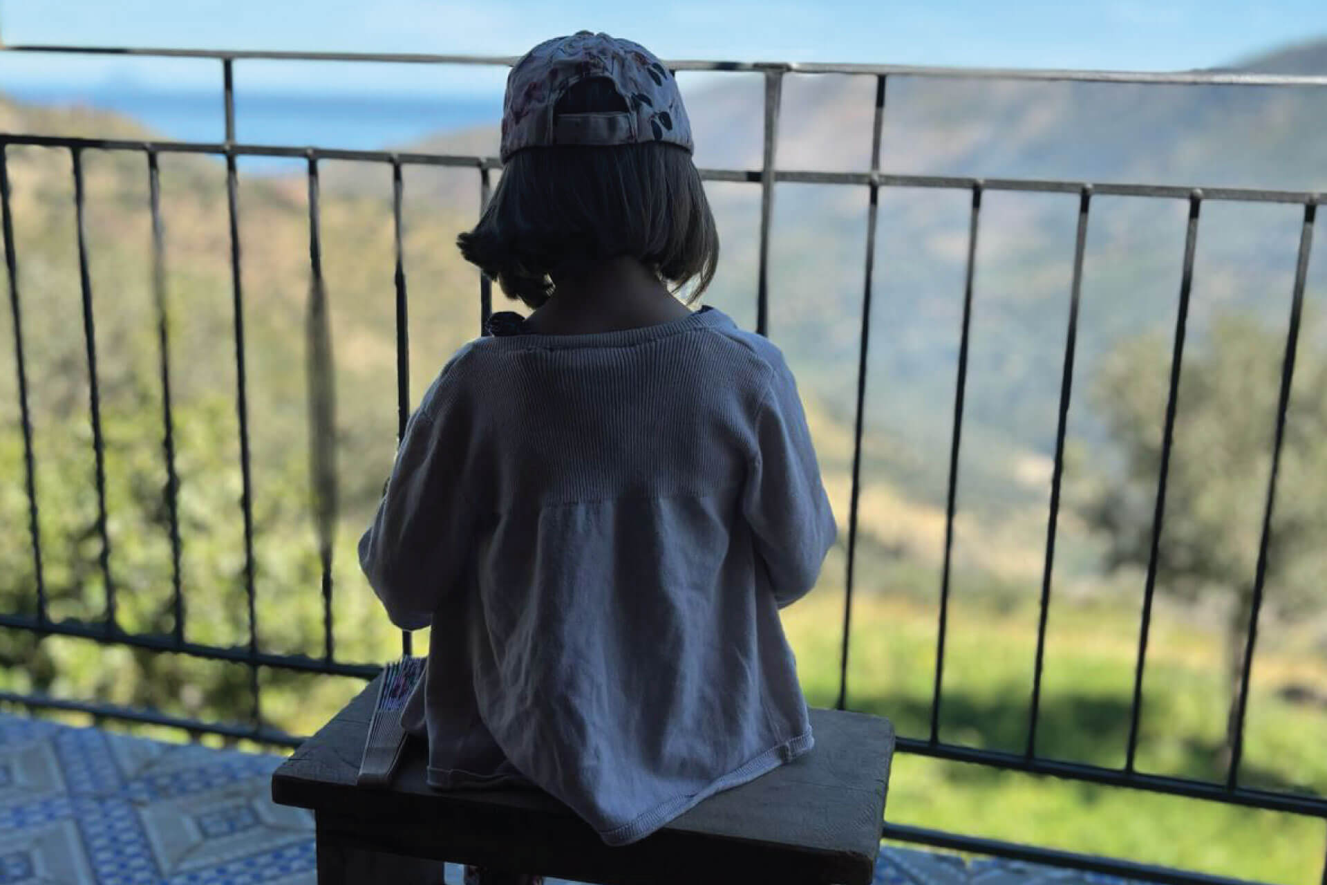 Guest relaxing with panoramic view of the Nebrodi Mountains during the country house retreat in Sicily
