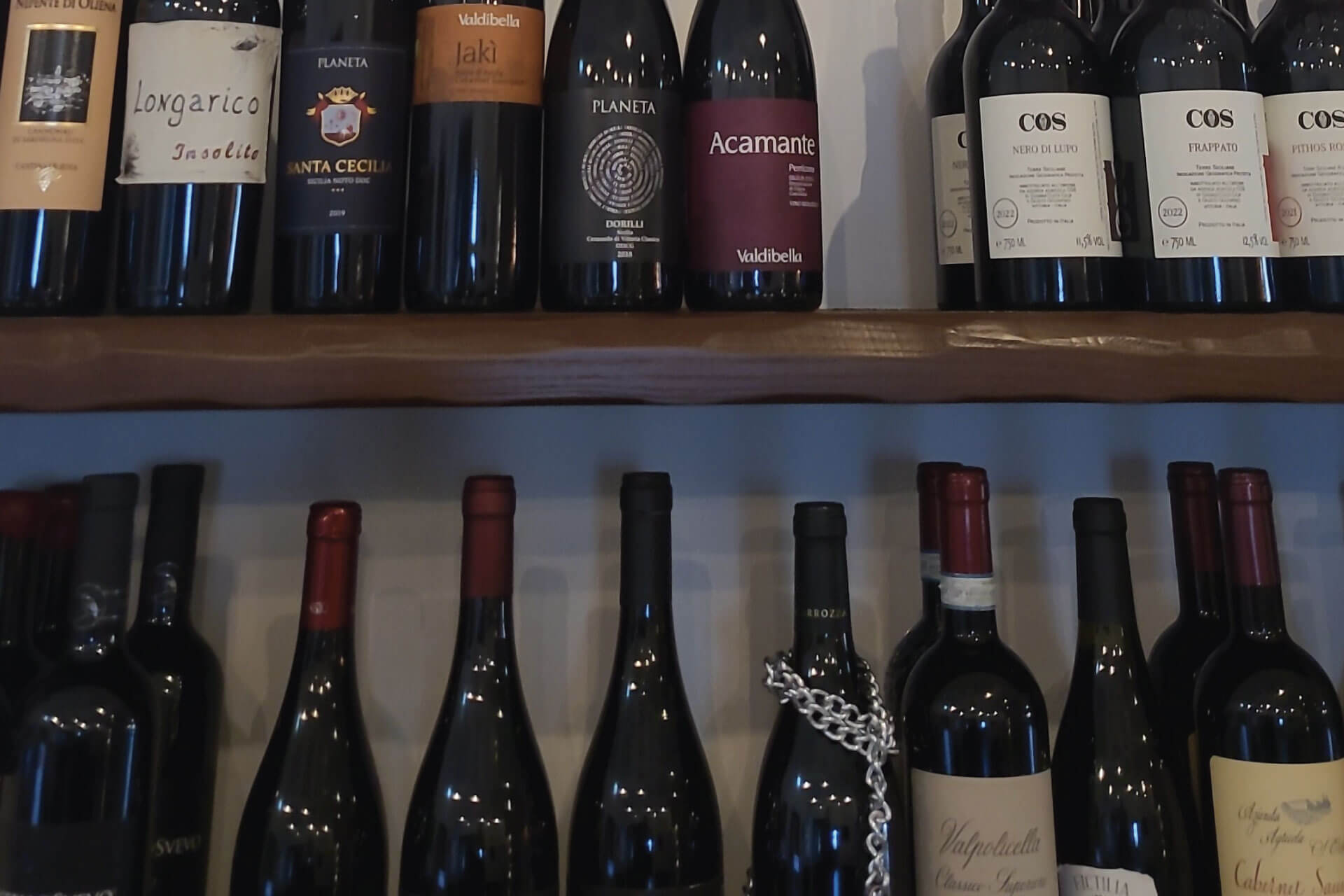Sicilian wine bottles displayed during a tasting event in Reitano, near Nebrodi Park